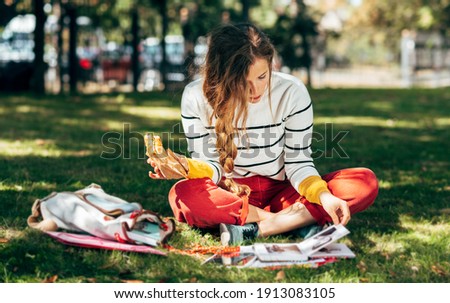 Similar – Image, Stock Photo Woman having lunch and browsing smartphone at home