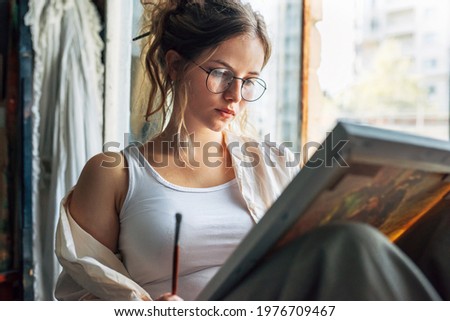 Similar – Image, Stock Photo Female artist drawing with pencil in art studio