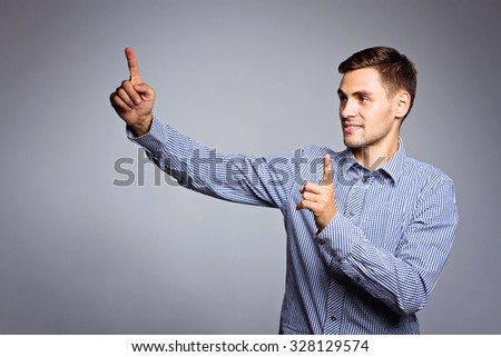 Business man showing something on gray background