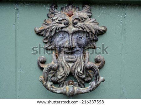 Old metal door knocker  with face