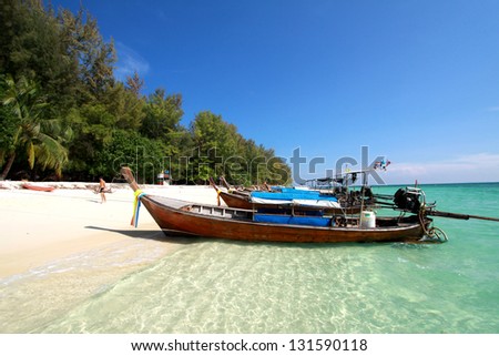 Thailand sea landscape. Nature background with travel boat, sand, blue sky and clear ocean water