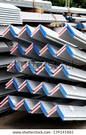 Arrangement of hot-dip galvanized steel angles on the rack in warehouse before shipment