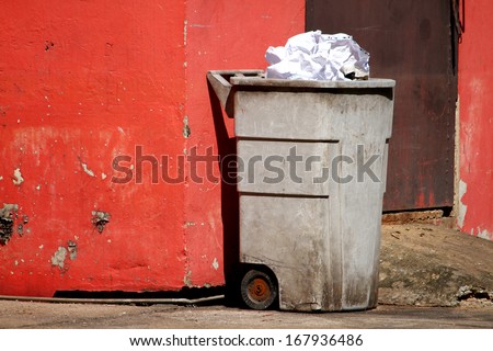 Bin on the red wall