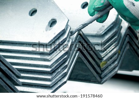 Arrangement of hot-dip galvanized steel angles on the rack in warehouse before shipment