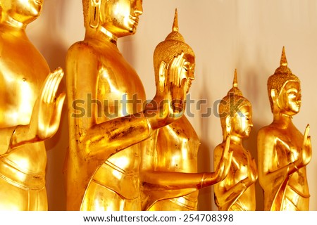 BANGKOK-THAILAND-JANUARY 1 : The row of golden Buddha Statue leela standing posture in wat pho temple on January 1, 2015 Bangkok, Thailand