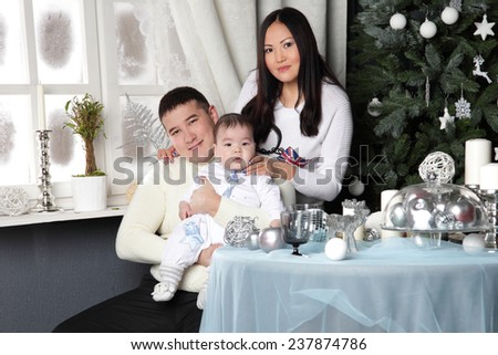 happy young family in the background Christmas tree for the holiday table