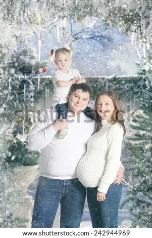 happy young family on a snow-covered terrace