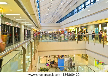 CHENGDU,CHINA - AUG 6,2011: People in the shopping mall at night.This is a big mall in chengdu,china.It is named WanDa plaza shopping mall.