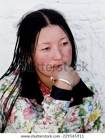 TIBET,CHINA - Aug 16,2013: woman christians on the street at tibet,china.