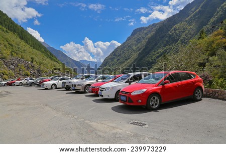 LIXIAN,CHINA - SEP 29,2014: rows of cars stop on the roadside at Songping valley with blue sky