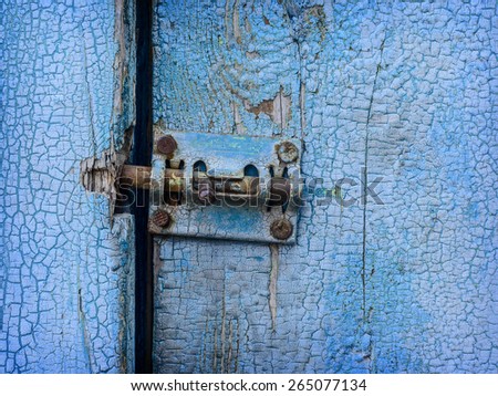 Espagnolette on old blue painted door close up