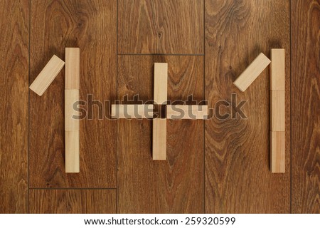 one plus one picture of wooden cubes of Jenga on wooden floor team design of wooden bars