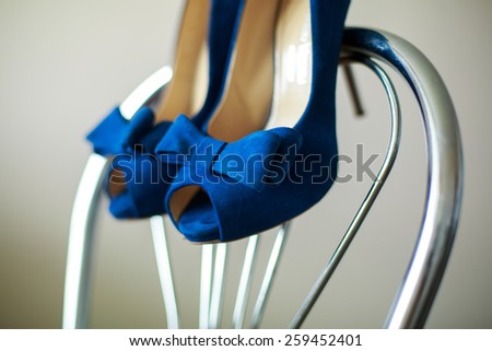beautiful bride shoes   beautiful girl in shoes with high heels elegant pair of blue shoes with heels  blue shoes on a chair