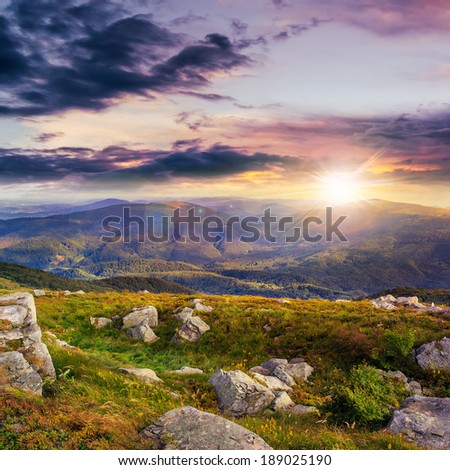 mountain landscape. valley with stones on the hillside. forest on the mountain under the beam of light falls on a clearing at the top of the hill. at sunset