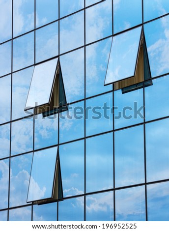 wall glass skyscraper with reflection of the sky and the three open windows