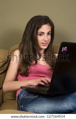 Happy teenage computer user. Teenage girl winning in a PC game