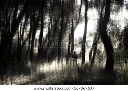 Man standing in a dark forest