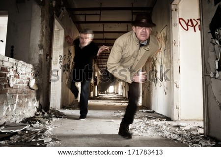 Man runs away from his chaser in an abandoned building