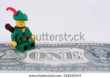 Venice, Italy - October 23, 2014: Robin Hood (as Lego figure) standing on  an American one dollar bill, October 23, 2014 in Venice, Italy