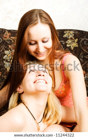 Two smiley women on the sofa