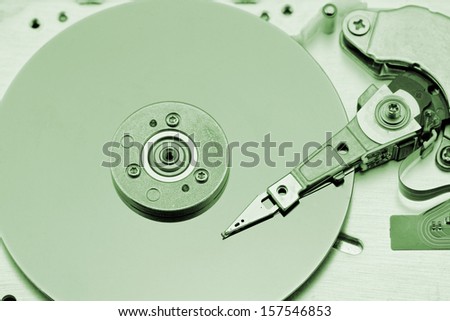 Open computer hard drive on white background with green (HDD, Winchester)