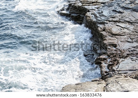 the rocky beach breaks the huge waves