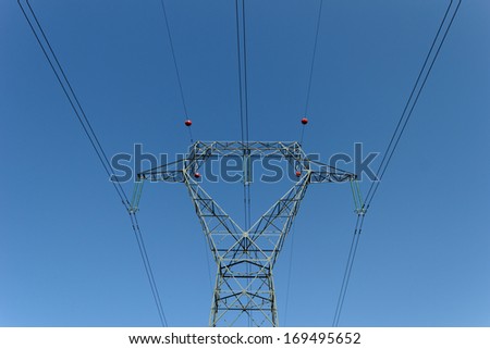 Detail of electricity pylon against blue sky