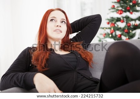young read haired girl relax on sofa of christmas stress