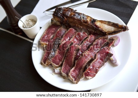 Prime rib with bone, cooked on the barbecue