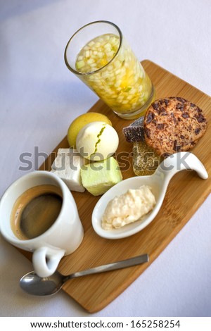 Dessert with coffee, fruit salad, cookie, macaroon, marshmallow