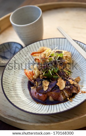 Japanese dish with beef sauce, fried vegetables, almonds and sal