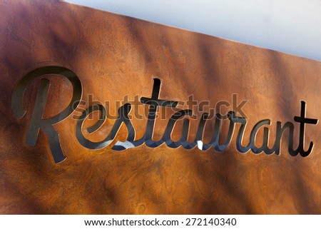 Rusty sign in the facade of a restaurant