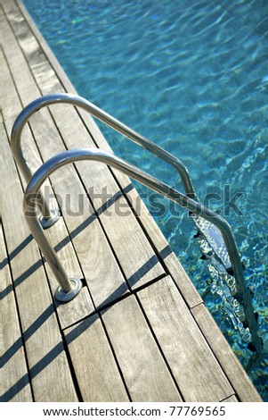 Swimming pool with ladder and wooden deck