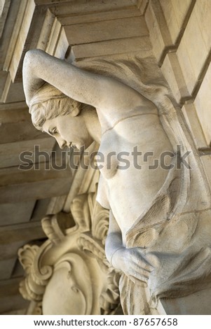 Statue on the facade of a mansion, in Bordeaux, France