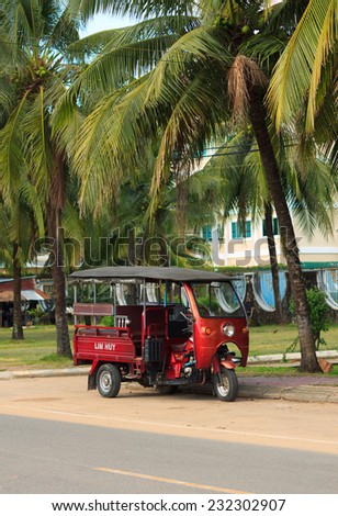 SIHANOUKVILLE, CAMBODIA - NOVEMBER 17, 2014: Tuk-tuk moto taxi parked on the street. Famous asian moto-taxi called tuk-tuk is a landmark of Asia and a popular public transport.