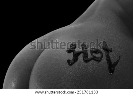 Closeup of woman's back with contrast lighting and black background
