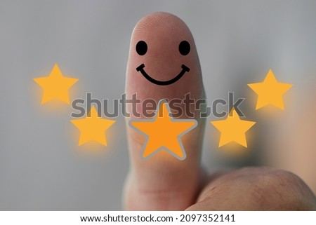 Customer satisfaction concept, 5-star satisfaction rating thumbs-up, and positive-emotional smiley faces showing excellent satisfaction.The concept of customer satisfaction improves 