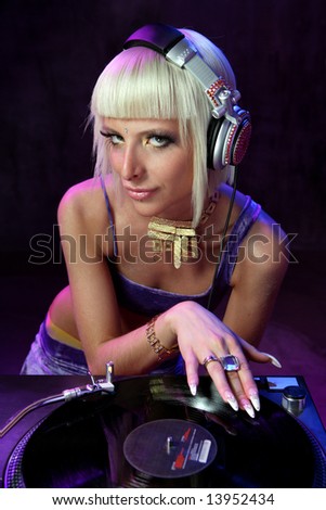 beautiful girl dj playing on vinyl player