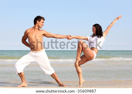 posing beautiful couple on the sea beach