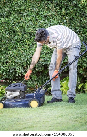 A man preparing for lawn mowing