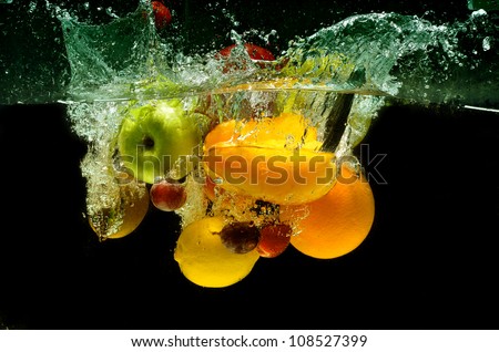 Splashing fruit on water. Fresh Fruit and Vegetables being  shot as they submerged under water.  Illustration of Washing food before being process further into a healthy and natural food