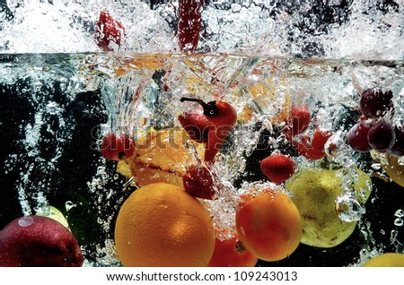 Fruit splash on water. Fresh and healthy fruit picture taken as they dramatically submerged into a clean water.