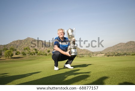HUA HIN, THAILAND - JANUARY 9: Colin Montgomerie, the captain of the European team, holds the Royal Trophy at the Black Mountain Golf Club in Hua Hin, Thailand, on January 9 2011.