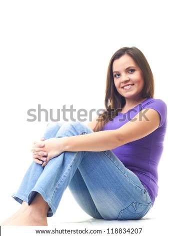 Attractive Smiling Young Woman In A Purple Shirt And Blue Jeans Sitting ...