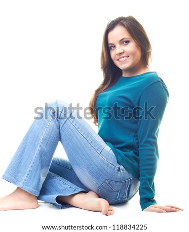 Attractive Smiling Young Woman In A Blue Shirt And Blue Jeans Sitting ...