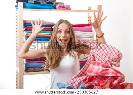 woman throws a pile of clothes, isolated on white background