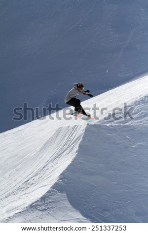 SOCHI, RUSSIA - MARCH 22, 2014: Snowboarder jumps in Snow Park,  mountain ski resort Rosa Khutor.