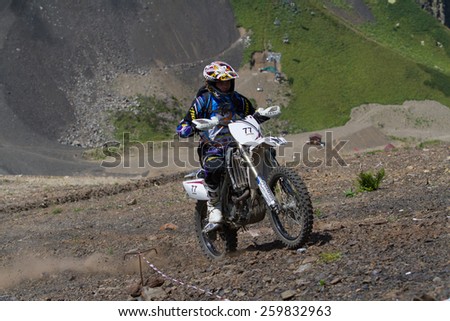 SOCHI, RUSSIA -?? AUGUST 16, 2014: Off-road motorcycle rider trains in summer mountains