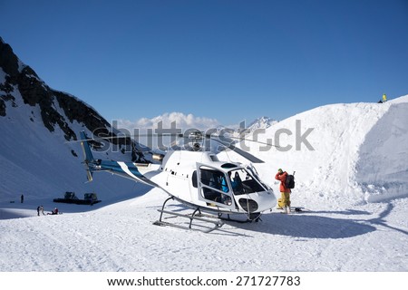 White rescue helicopter parked in the snowy mountains