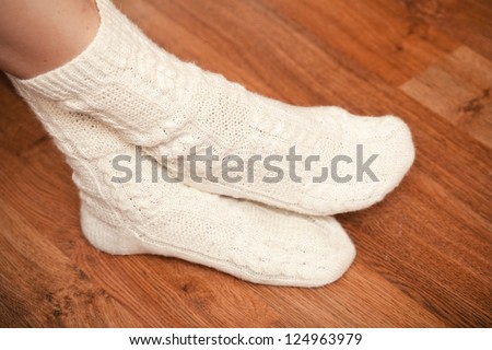 knitted white socks on woman\'s feet